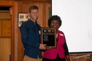 Dylan Kraus, an AgBiome Entomologist, receiving the silver sneaker award from the Durham Crop Walk.